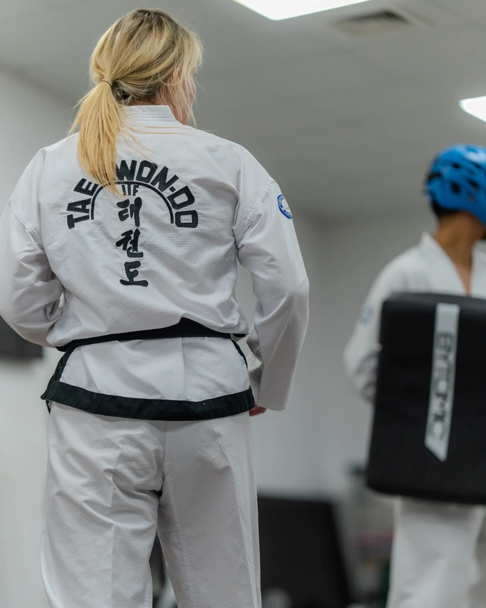 Taekwondo students training in protective equipment